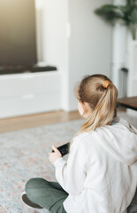 Girl playing video game at home