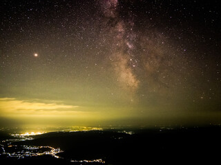 Starry Sky Over the City: A Sea of Lights and the Milky Way