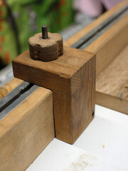 DIY cross cut sled on a table saw. A piece of wood will be cut. 