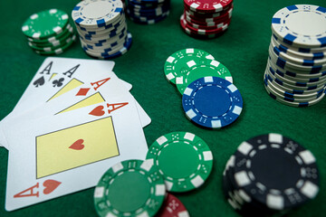 poker chips with win combination four aces cards  at casino table