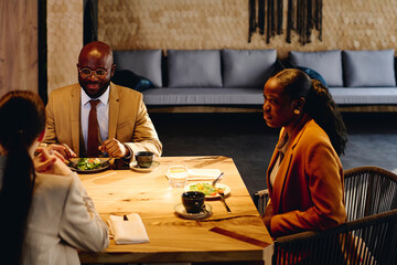 Business colleagues discussing on dining table at convention center