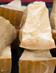 Parmesan Cheese Pieces Wrapped with Plastic Food Wrap, Italian Parmigiano Reggiano