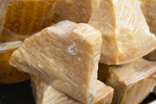 Parmesan Cheese Pieces Wrapped With Plastic Food Wrap, Italian Parmigiano Reggiano