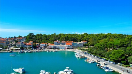 Fototapeta na wymiar Rab - Croatia - An aerial view with the drone over the beautiful town of Rab - The drone rises above the town of Rab and the marina and opens up a fantastic view of the Croatian islands