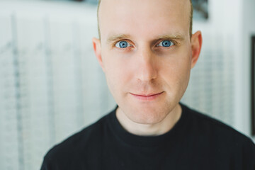 A young man chooses glasses in an ophthalmology salon. Bad eyesight.