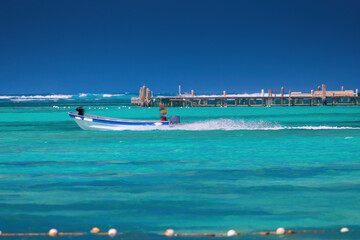 Speed boat surfing over the clear water of caribbean sea, summer tropical vacation