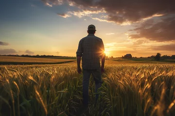 Foto auf Acrylglas Dunkelbraun Farmer looking over his farm field