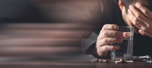Caucasian depressed man with a pills.