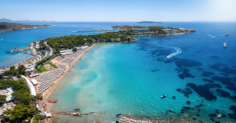 Aerial view of the beautiful beach of Astir at the bay of Vouliagmeni, Athens, with turquoise and emerald sea
