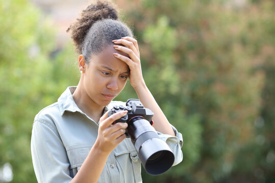 Black photographer complaining checking photos on camera