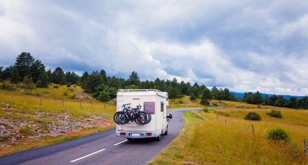 Family in motorhome on the road in countryside- vacation, road trip,adventure concept- Lozere,...