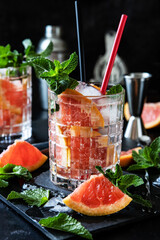 Citrus fruit cocktail with   mint in glass, selective focus