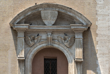 Baroque arch on the door with pigeons