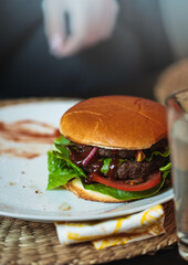 A home cooked burger eaten at a family dinner, golden burger bun cheeseburger with fries