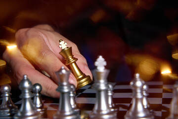 hand of businessman  wearing suit moving chess using strategic challenge idea  ,  business competition planing teamwork strategic concept.