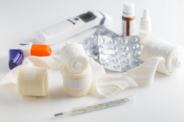 Home pharmacy, first aid kit concept with medical bandages, pills, thermometer and inhalator