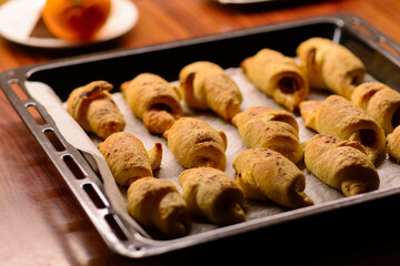 Just out of the oven, freshly baked mini croissants with a crispy crust.