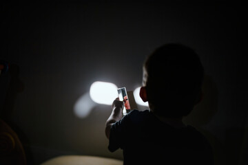 Child holds crystal glass prism reflecting shiny, 3D sphere. Curiosity shows in his exploration of...