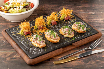 bruschetta with seafood made with Asian flavors on a stone cutting board