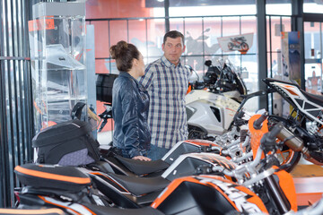 couple buying in a motorbike store