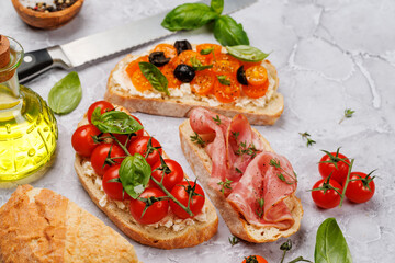 Sandwich set of bruschetta with juicy tomatoes, cheese and prosciutto