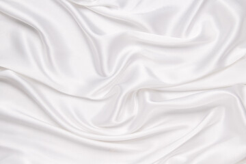 Obraz premium Abstract white fabric texture background. Cloth soft wave. Creases of satin, silk, and cotton.