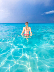 A girl entering the water. Atlantic Ocean, Varadero, Cuba.