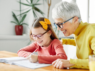 grandchild grandmother family granddaughter child teacher homework creativity home woman book notebook grandma education classroom grandparent parent daughter girl kid teaching