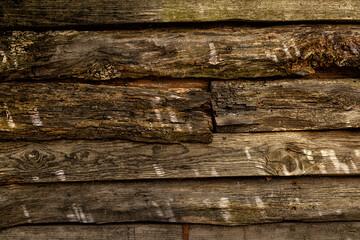 Wood texture background, aged wooden brown surface with lights spots, old fence.