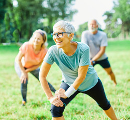 outdoor senior fitness woman man lifestyle active sport exercise healthy fit retirement stretching elderly couple training class clothing © Lumos sp