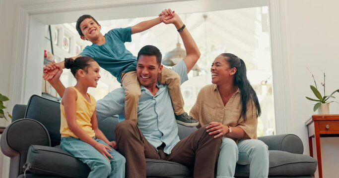 Family, together on sofa and children on dad shoulders for fun, bonding or quality time in living room with mom and girl. Couple, kids and laughing at funny game, balance or support in house