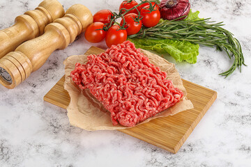 Raw minced beef meat on cutting board