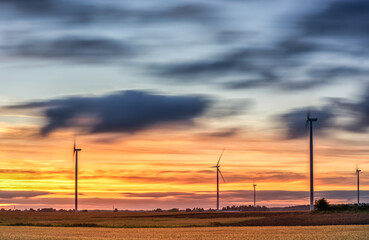 Fototapeta premium Windmill in Nature. Blurry Cloudy Sky. Long Exposure. Beautiful Nature