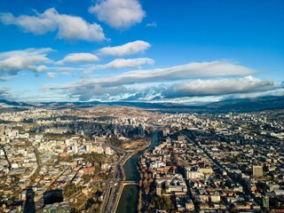 Fototapeta premium Aerial view of the cityscape with a cloudy blue sky in the background, Tbilisi, Georgia