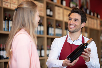 winemaker holding one bottle in his hands