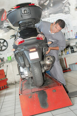 a mechanic is working on scooter