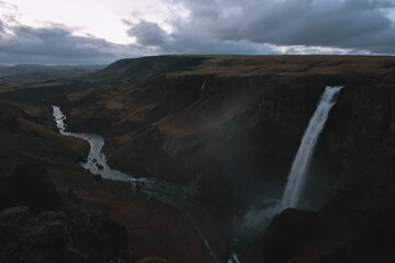 Stunning aerial view of a powerful Haifoss waterfall cascading down a rocky mountainside in Iceland