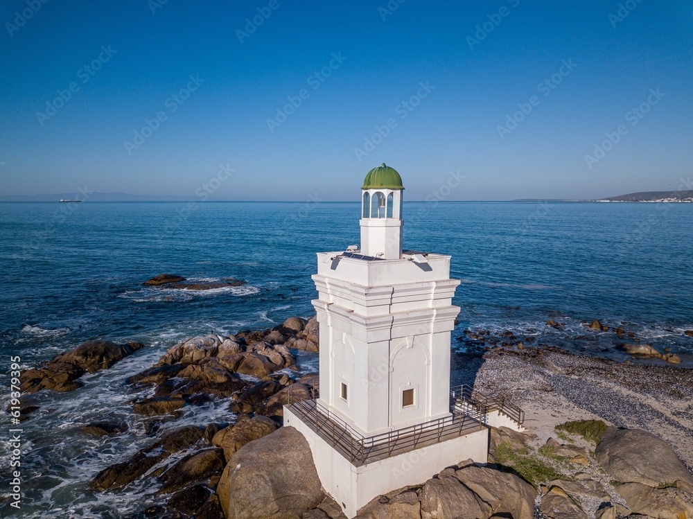 Sticker shelley point lighthouse on a rocky beach on a sunny day in south africa