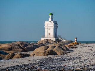 Fototapeta na wymiar Shelley Point lighthouse on a rocky beach on a sunny day in South Africa