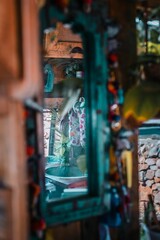 Obraz premium Vertical shot of the reflection of rustic kitchen interior in the mirror of a house