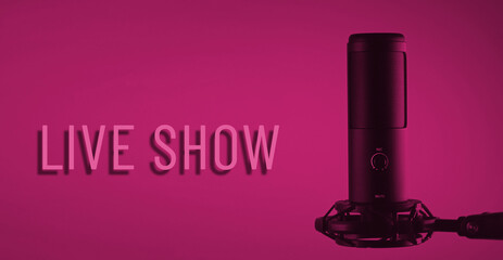 A studio condenser microphone with LIVE SHOW written on a colored background.
