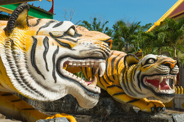 Statues of tigers at entrance to buddhist pagoda Tham Sua near Tiger Cave Temple in Krabi, Thailand