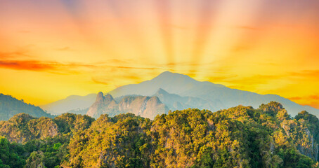 Sunset landscape green mountains with tropical jungle forest and sunset sun