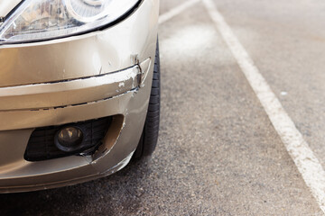 Car bumper scratched with deep paint damage. Dent scratch car. Broken car in an accident.