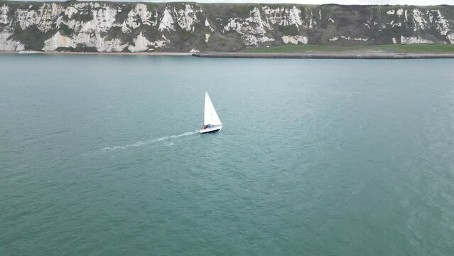 Aerial view of a sailing boat off the coast of Folkestone, near Samphire Hoe
