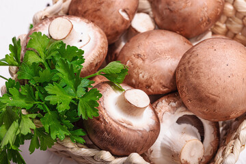 Raw brown royal champignons in the basket. Cooking vegan food concept. Garlic, greens, spices