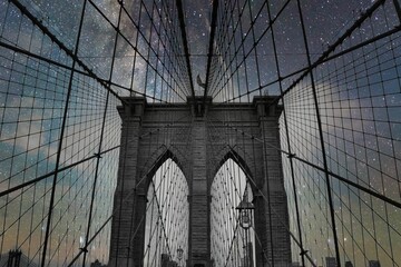 the brooklyn bridge under a starr sky in black and white