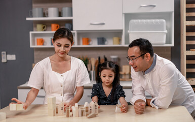 Parents teach values to their daughter and develop efficient habits via hardwood toys to save for future housing. Guided and inspired learning and supportive encouragement to build lifelong character