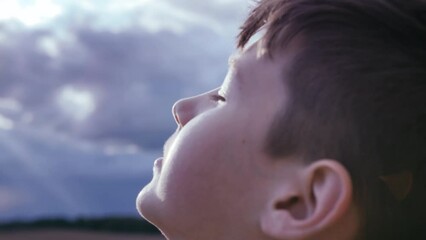 A Child's Radiant Connection: Embracing the Sunlight Amidst Rainy Skies