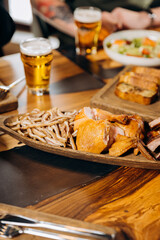 Beer appetizer. Smoked chicken fillet whole and sliced on wooden board. Rustic organic food, top view